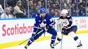 Nov 20, 2025; Toronto, Ontario, CAN; Toronto Maple Leafs right wing William Nylander (88) battles with Columbus Blue Jackets defenseman Dante Fabbro (15) during the third period at Scotiabank Arena. Mandatory Credit: Nick Turchiaro-Imagn Images