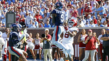 Oct 26, 2024; Oxford, Mississippi, USA; Mississippi Rebels defensive back Trey Amos (9) catches the ball as he steps out of bounds over Oklahoma Sooners running back Taylor Tatum (8) during the first half at Vaught-Hemingway Stadium. Mandatory Credit: Petre Thomas-Imagn Images