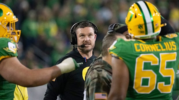 Oregon head coach Dan Lanning gathers his team during a timeout as the Oregon Ducks host the Maryland Terrapins at Autzen Sta
