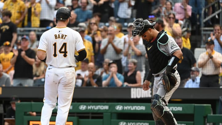 Aug 3, 2024; Pittsburgh, Pennsylvania, USA;  Pittsburgh Pirates batter Joey Bart (14) crosses home plate in front of Arizona Diamondbacks catcher Gabriel Moreno(14) after hitting a solo home run in the second inning at PNC Park. Mandatory Credit: Philip G. Pavely-USA TODAY Sports