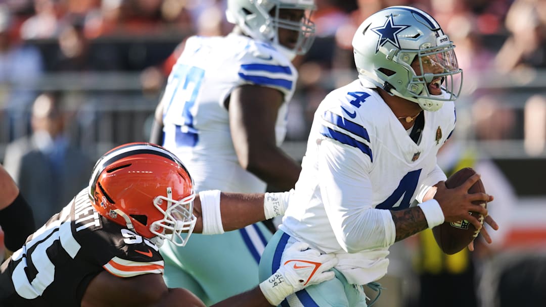 Sep 8, 2024; Cleveland, Ohio, USA; Dallas Cowboys quarterback Dak Prescott (4) is tackled by Cleveland Browns defensive end Myles Garrett (95) during the first half at Huntington Bank Field. Mandatory Credit: Ken Blaze-Imagn Images