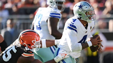 Sep 8, 2024; Cleveland, Ohio, USA; Dallas Cowboys quarterback Dak Prescott (4) is tackled by Cleveland Browns defensive end Myles Garrett (95) during the first half at Huntington Bank Field. Mandatory Credit: Ken Blaze-Imagn Images