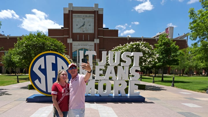 Chris Splitt and his wife Rhonda take a photo with an SEC sign outside Gaylord Family-Oklahoma Memorial Stadium in Norman, Okla., during a celebration for OU joining the Southeastern Conference in Norman, Okla., Monday, July 1, 2024.