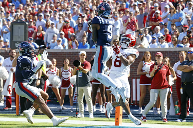 Mississippi Rebels defensive back Trey Amos intercepts the ball as he steps out of bounds over Oklahoma's Taylor Tatum.
