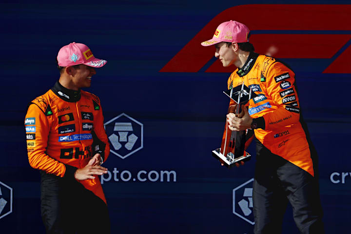 McLaren driver Oscar Piastri celebrates with the winners trophy while talking to teammate Lando Norris after the Miami G