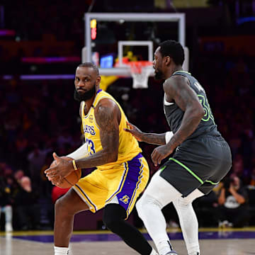 Apr 30, 2025; Los Angeles, California, USA; Los Angeles Lakers forward LeBron James (23) controls the ball against Minnesota Timberwolves forward Julius Randle (30) during the first half in game five of first round for the 2025 NBA Playoffs at Crypto.com Arena. Mandatory Credit: Gary A. Vasquez-Imagn Images