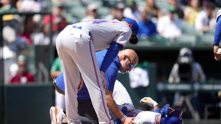 Apr 12, 2025; West Sacramento, California, USA; New York Mets center fielder Jose Siri (19) lays on the ground after suffering an injury against the Athletics in the second inning at Sutter Health Park. Mandatory Credit: Cary Edmondson-Imagn Images