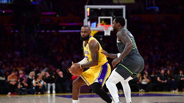 Apr 30, 2025; Los Angeles, California, USA; Los Angeles Lakers forward LeBron James (23) controls the ball against Minnesota Timberwolves forward Julius Randle (30) during the first half in game five of first round for the 2025 NBA Playoffs at Crypto.com Arena. Mandatory Credit: Gary A. Vasquez-Imagn Images