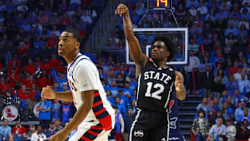 Feb 15, 2025; Oxford, Mississippi, USA; Mississippi State Bulldogs guard Josh Hubbard (12) holds after shooting for three over Mississippi Rebels guard Matthew Murrell (11) during the first half at The Sandy and John Black Pavilion at Ole Miss. Mandatory Credit: Petre Thomas-Imagn Images