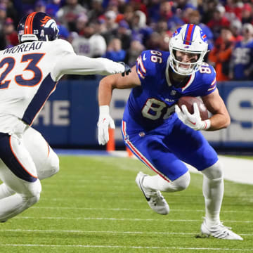 Nov 13, 2023; Orchard Park, New York, USA; Buffalo Bills tight end Dalton Kincaid (86) runs with the ball after making a catch against Denver Broncos cornerback Fabian Moreau (23) during the first half at Highmark Stadium. Mandatory Credit: Gregory Fisher-USA TODAY Sports