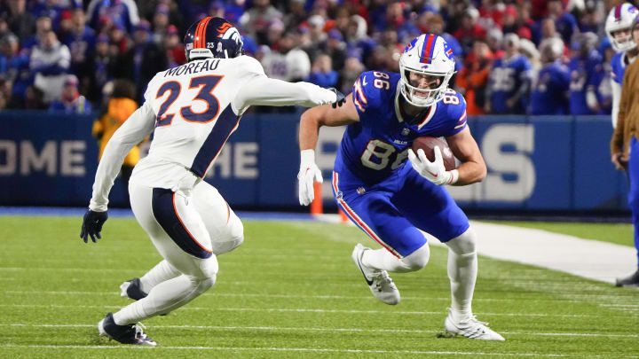 Nov 13, 2023; Orchard Park, New York, USA; Buffalo Bills tight end Dalton Kincaid (86) runs with the ball after making a catch against Denver Broncos cornerback Fabian Moreau (23) during the first half at Highmark Stadium. Mandatory Credit: Gregory Fisher-USA TODAY Sports