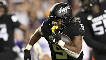Oct 26, 2024; College Station, Texas, USA; Texas A&M Aggies running back Amari Daniels (5) runs the ball against the LSU Tigers during the fourth quarter. The Aggies defeated the Tigers 38-23; at Kyle Field. Mandatory Credit: Maria Lysaker-Imagn Images.  