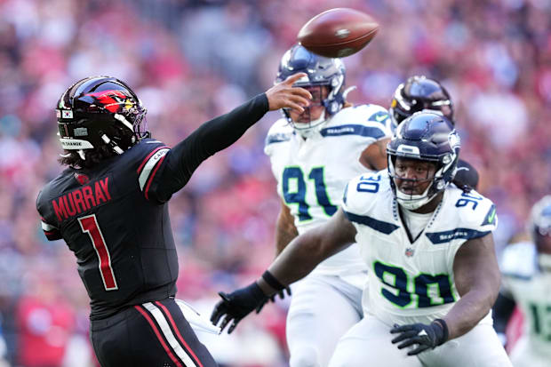 Arizona Cardinals quarterback Kyler Murray (1) throws while being pressured