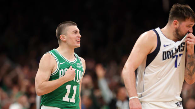 Boston Celtics guard Payton Pritchard (11) reacts after making a basket shot from the center line with the final siren