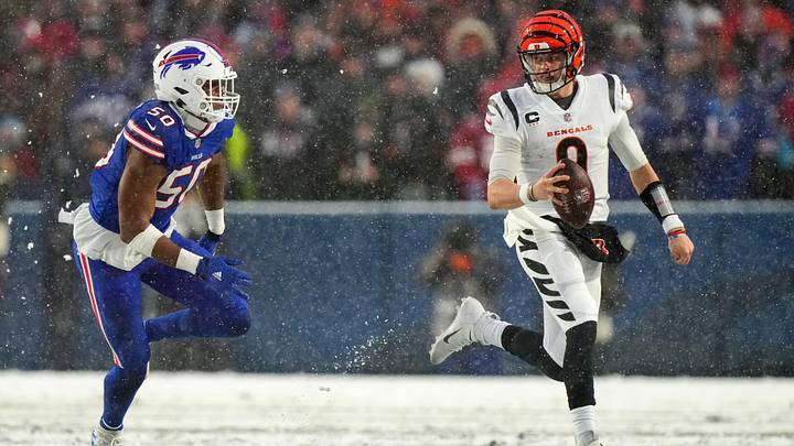 Cincinnati Bengals quarterback Joe Burrow (9) carries the ball as Buffalo Bills defensive end Greg Rousseau (50) defends in the second quarter during an NFL divisional playoff football game between the Cincinnati Bengals and the Buffalo Bills, Sunday, Jan. 22, 2023, at Highmark Stadium in Orchard Park, N.Y.

Cincinnati Bengals At Buffalo Bills Afc Divisional Jan 22 1207