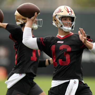 Jul 24, 2025; Santa Clara, CA, USA; San Francisco 49ers quarterbacks Tanner Mordecai (14) and Brock Purdy (13) throw during a passing drill on the second day of training camp. Mandatory Credit: D. Ross Cameron-Imagn Images