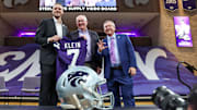 Collin Klein, athletic director Gene Taylor and K-State President Richard Litton hold a jersey after Klein was named the new head coach of the Kansas State Wildcats football team at Morgan Family Arena.