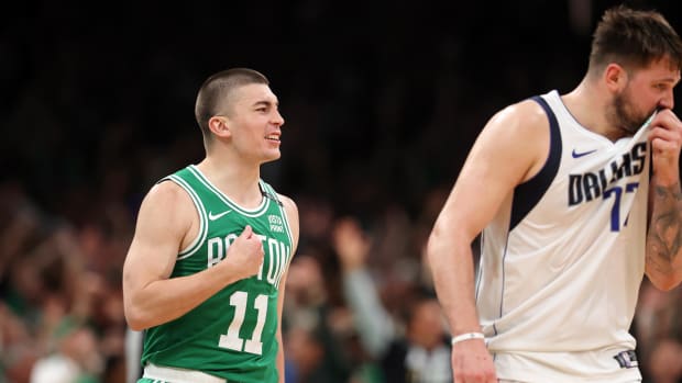 Boston Celtics guard Payton Pritchard reacts after making a half-court shot at the buzzer to end the second quarter.