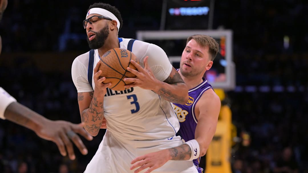 Nov 28, 2025; Los Angeles, California, USA;  Dallas Mavericks forward Anthony Davis (3) is defended by Los Angeles Lakers guard Luka Doncic (77) as he handles the ball in the second half at Crypto.com Arena. Mandatory Credit: Jayne Kamin-Oncea-Imagn Images