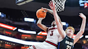 Louisville Cardinals guard Koren Johnson (3) gets two plus the foul against Spalding University's Levi Langley (21) in the second half in the Cards' second exhibition game against Spalding University at the KFC Yum! Center in Louisville, Kentucky Monday, Oct. 28, 2024.