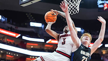 Louisville Cardinals guard Koren Johnson (3) gets two plus the foul against Spalding University's Levi Langley (21) in the second half in the Cards' second exhibition game against Spalding University at the KFC Yum! Center in Louisville, Kentucky Monday, Oct. 28, 2024.