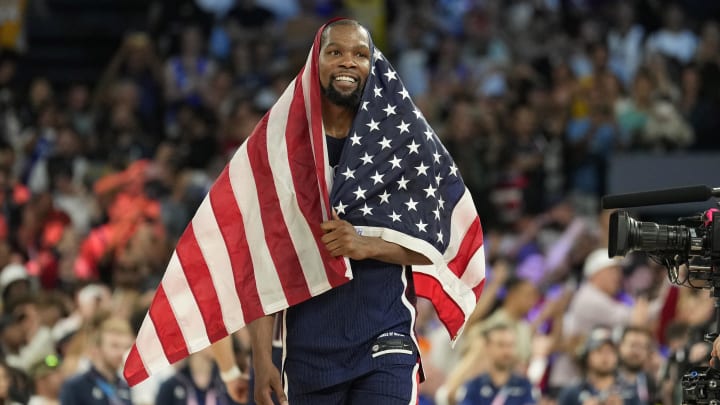 Aug 10, 2024; Paris, France; United States guard Kevin Durant (7) celebrates after defeating France in the men's basketball gold medal game during the Paris 2024 Olympic Summer Games at Accor Arena. Mandatory Credit: Kyle Terada-USA TODAY Sports