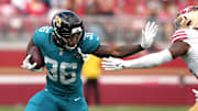 Sep 28, 2025; Santa Clara, California, USA; Jacksonville Jaguars running back LeQuint Allen Jr. (36) runs after a catch against San Francisco 49ers linebacker Dee Winters (right) during the second quarter at Levi's Stadium. Mandatory Credit: Darren Yamashita-Imagn Images