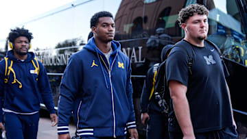 Michigan defensive back Will Johnson (2), center, and defensive lineman Mason Graham (55) walk towards locker room as the team arrive before the Michigan State game at Michigan Stadium in Ann Arbor on Saturday, Oct. 26, 2024.