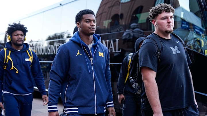 Michigan defensive back Will Johnson (2), center, and defensive lineman Mason Graham (55) walk towards locker room as the team arrive before the Michigan State game at Michigan Stadium in Ann Arbor on Saturday, Oct. 26, 2024.