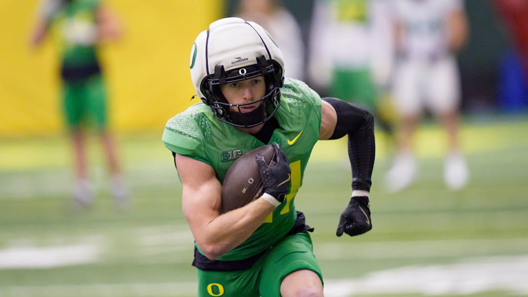 Oregon defensive back Dillon Thieneman carries the ball as the Oregon Ducks practice on Jan. 5, 2025, at the Moshofsky Center in Eugene, Oregon, ahead of the Peach Bowl.