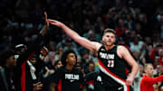 Nov 19, 2025; Portland, Oregon, USA; Portland Trail Blazers center Donovan Clingan (23) celebrates a basket and a foul with teammates during the second half against the Chicago Bulls at Moda Center. Mandatory Credit: Soobum Im-Imagn Images