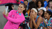 San Diego Wave FC forward Alex Morgan takes a photo with one of her fans on June 7
