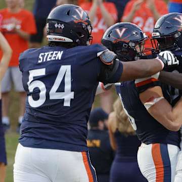 Oct 12, 2024; Charlottesville, Virginia, USA; Virginia Cavaliers running back Xavier Brown (0) celebrates with teammates after scoring a touchdown against the Louisville Cardinals during the second half at Scott Stadium. Mandatory Credit: Amber Searls-Imagn Images