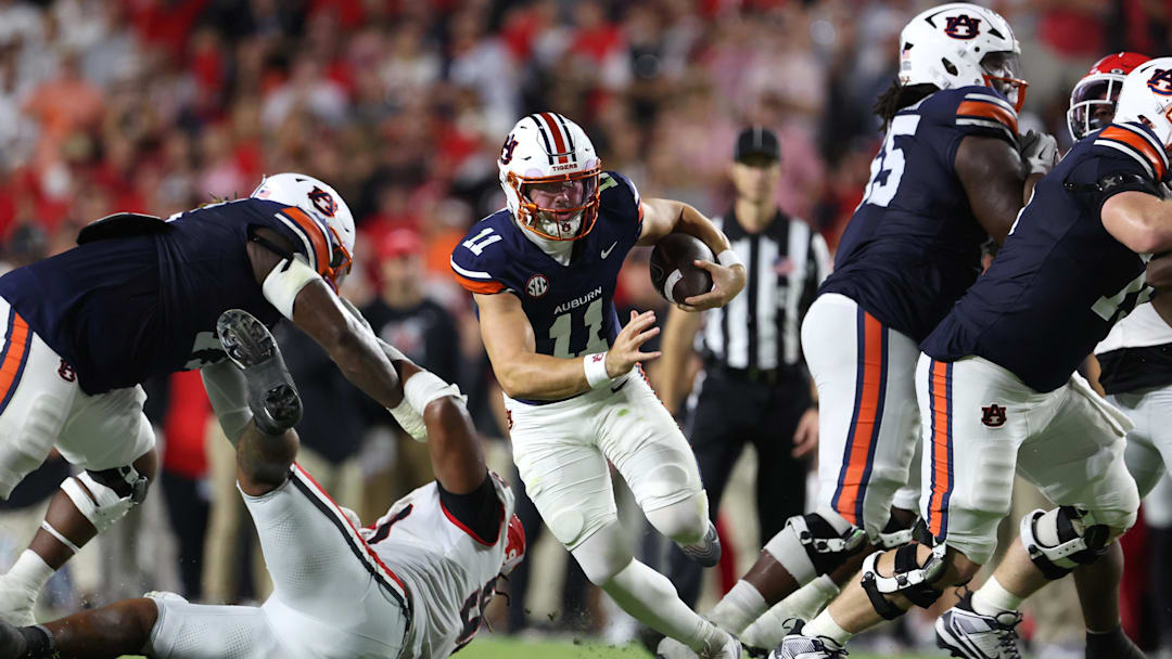 Oct 11, 2025; Auburn, Alabama, USA;  Auburn Tigers quarterback Jackson Arnold (11) carries during the second quarter against the Georgia Bulldogs at Jordan-Hare Stadium. Mandatory Credit: John Reed-Imagn Images
