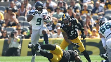 Sep 14, 2025; Pittsburgh, Pennsylvania, USA;  Seattle Seahawks running back Kenneth Walker III (9) leaps over Pittsburgh Steelers defensive tackle Yaha Black (bottom) on a second quarter carry at Acrisure Stadium. Mandatory Credit: Charles LeClaire-Imagn Images