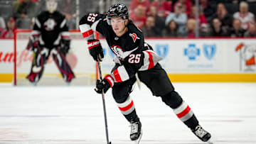 Owen Power (25) carrying the puck in a game against the Detroit Red Wings. 