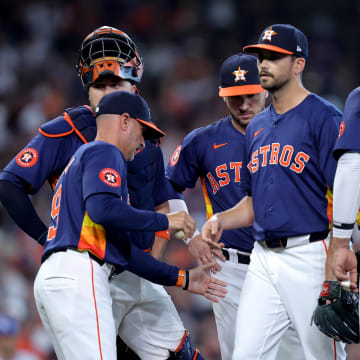 Jul 28, 2024; Houston, Texas, USA; Houston Astros manager Joe Espada (19) takes the game ball from Houston Astros pitcher Seth Martinez (61) during the seventh inning against the Los Angeles Dodgers at Minute Maid Park.