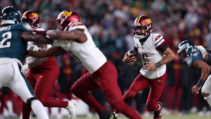 Washington Commanders quarterback Jayden Daniels runs with the ball against the Philadelphia Eagles.