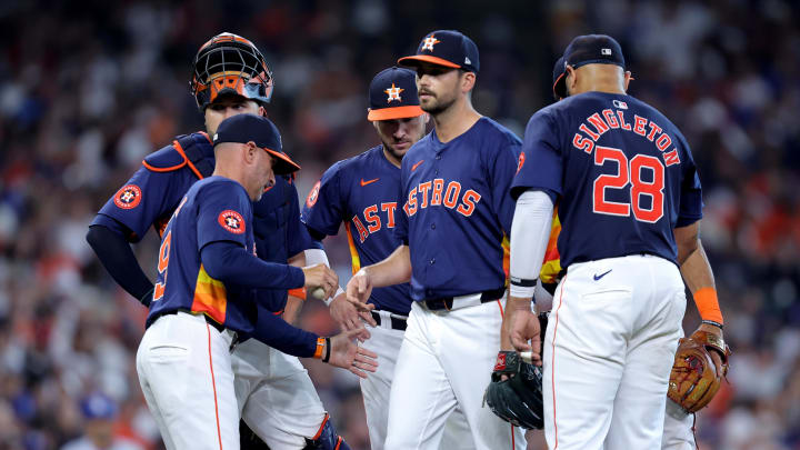 Jul 28, 2024; Houston, Texas, USA; Houston Astros manager Joe Espada (19) takes the game ball from Houston Astros pitcher Seth Martinez (61) during the seventh inning against the Los Angeles Dodgers at Minute Maid Park.