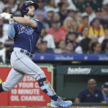 Jul 28, 2023; Houston, Texas, USA; Tampa Bay Rays second baseman Brandon Lowe (8) hits a three-run home run during the first inning against the Houston Astros at Minute Maid Park.