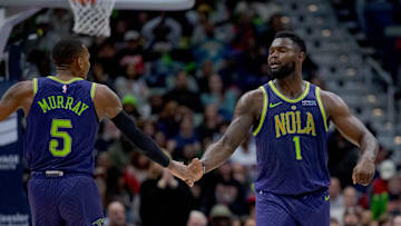 Jan 7, 2025; New Orleans, Louisiana, USA; New Orleans Pelicans guard Dejounte Murray (5) and New Orleans Pelicans forward Zion Williamson (1) celebrate a three-point basket made by Murray with an assist from Williamson during the first half against the Minnesota Timberwolves at Smoothie King Center. 