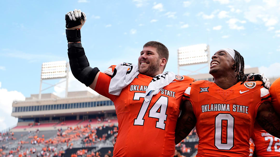 Oklahoma State's Preston Wilson (74) and Ollie Gordon II (0) celebrate following the college football game between the Oklahoma State Cowboys and South Dakota State Jackrabbits at Boone Pickens Stadium in Stillwater, Okla., Saturday, Aug., 31, 2024.