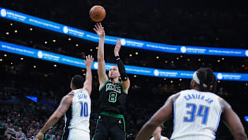 Apr 29, 2025; Boston, Massachusetts, USA; Boston Celtics center Kristaps Porzingis (8) shoots the ball against Orlando Magic guard Cory Joseph (10) in the third quarter during game five of first round for the 2025 NBA Playoffs at TD Garden. Mandatory Credit: David Butler II-Imagn Images