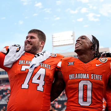 Oklahoma State's Preston Wilson (74) and Ollie Gordon II (0) celebrate following the college football game between the Oklahoma State Cowboys and South Dakota State Jackrabbits at Boone Pickens Stadium in Stillwater, Okla., Saturday, Aug., 31, 2024.