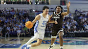 Nov 25, 2025; Fort Myers, Florida, USA; North Carolina Tar Heels guard Luka Bogavac (44) drives to the basket past St. Bonaventure Bonnies guard Amar’E Marshall (2) in the first half at Suncoast Credit Union Arena. Mandatory Credit: Nathan Ray Seebeck-Imagn Images