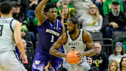 Jan 21, 2025; Eugene, Oregon, USA; Oregon Ducks forward Supreme Cook (7) drives against Washington Huskies forward Great Osobor (1) during the second half at Matthew Knight Arena. Mandatory Credit: Craig Strobeck-Imagn Images