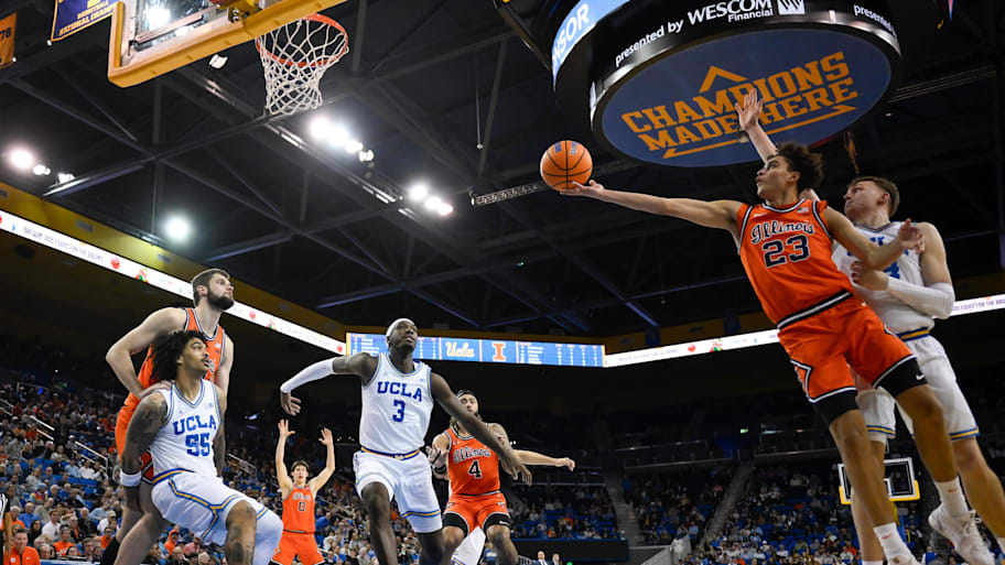 Illinois guard Keaton Wagler (23) drives to the basket past UCLA forward Tyler Bilodeau 