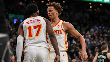Onyeka Onkonwu #17 and Dyson Daniels #5 of the Atlanta Hawks celebrate against the Boston Celtics.