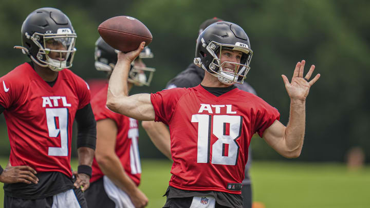 Jun 3, 2024; Atlanta, GA, USA; Atlanta Falcons quarterback Kirk Cousins (18) throws while quarterback Michael Penix Jr (9) watches on the field during Falcons OTA at the Falcons Training facility. Mandatory Credit: Dale Zanine-USA TODAY Sports