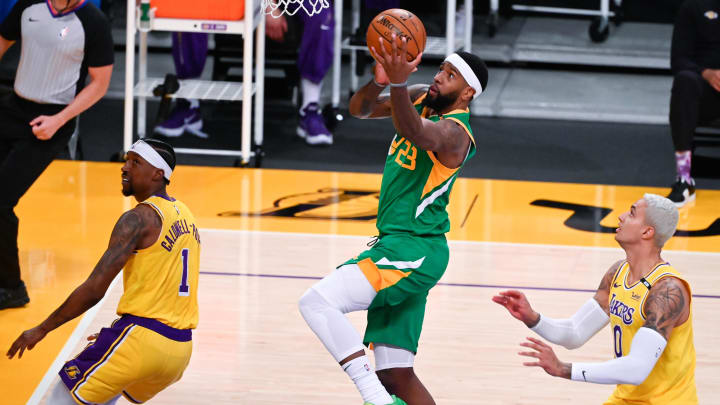 Apr 19, 2021; Los Angeles, California, USA; Utah Jazz forward Royce O'Neale (23) goes to the basket between Los Angeles Lakers guard Kentavious Caldwell-Pope (1) and Los Angeles Lakers forward Kyle Kuzma (0) during the first quarter at Staples Center. Mandatory Credit: Robert Hanashiro-USA TODAY Sports